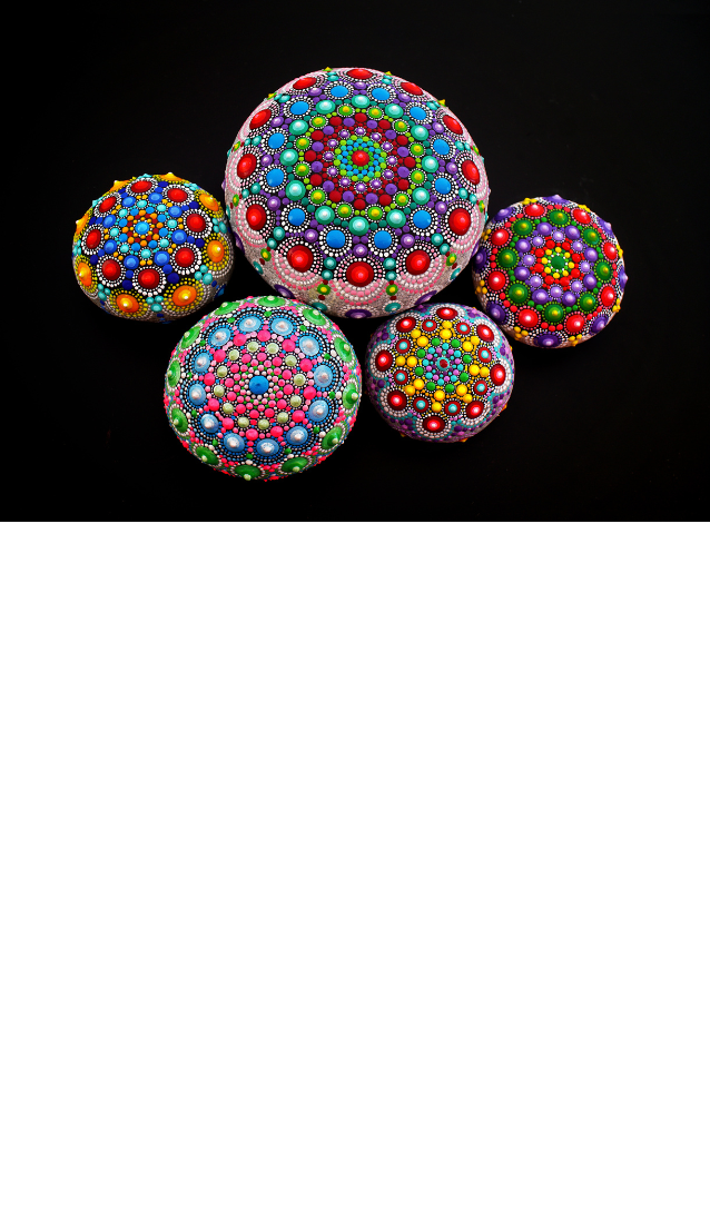 Mandala painted rocks on a black background